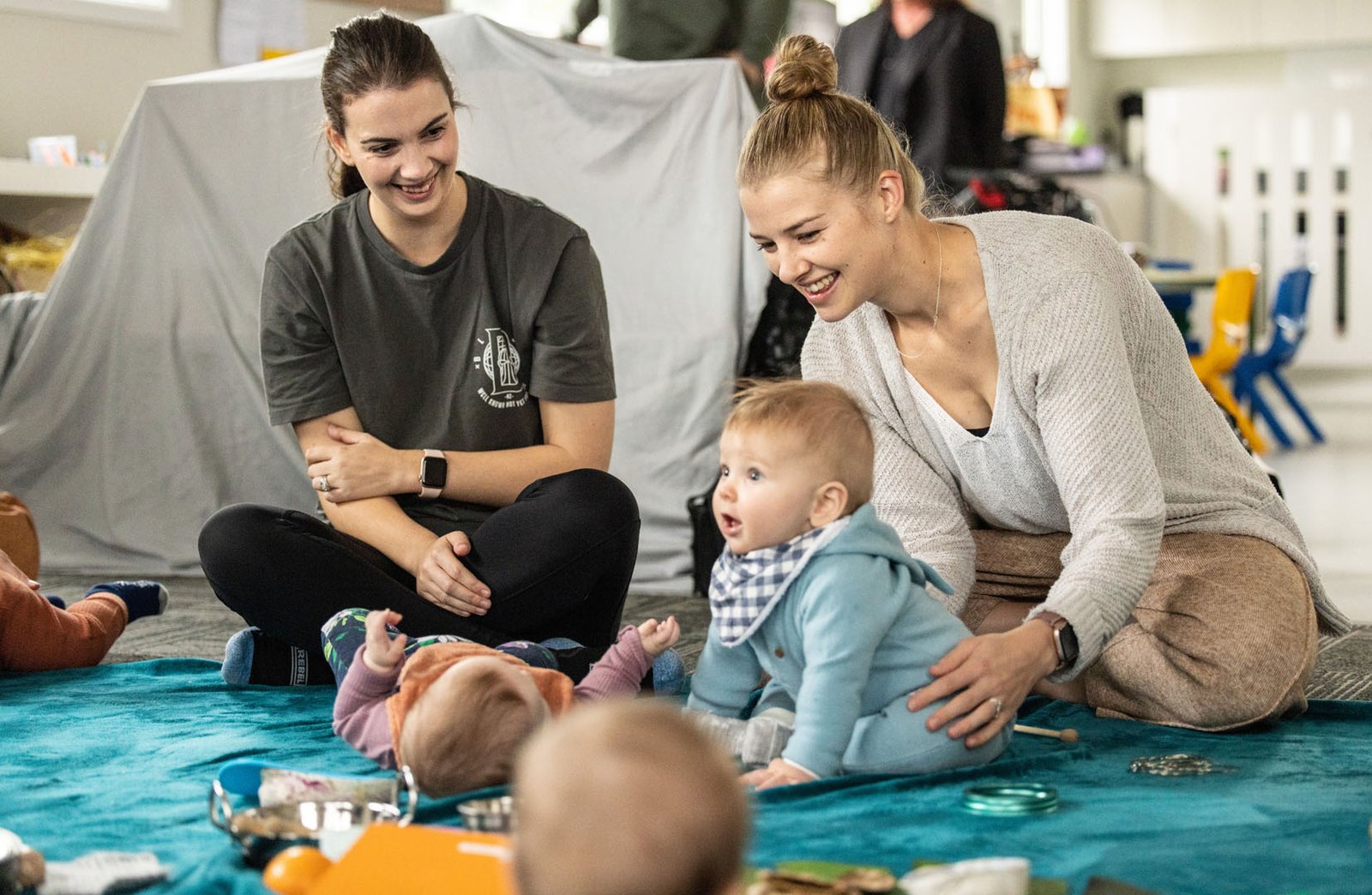 Image of two mother their babies playing