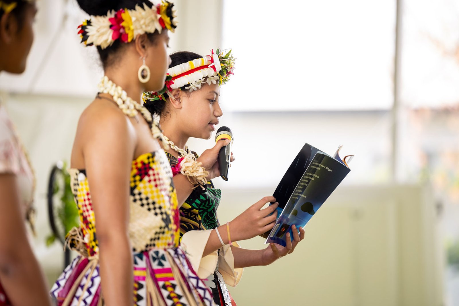 Image of a women holding a microphone for her friend speaking